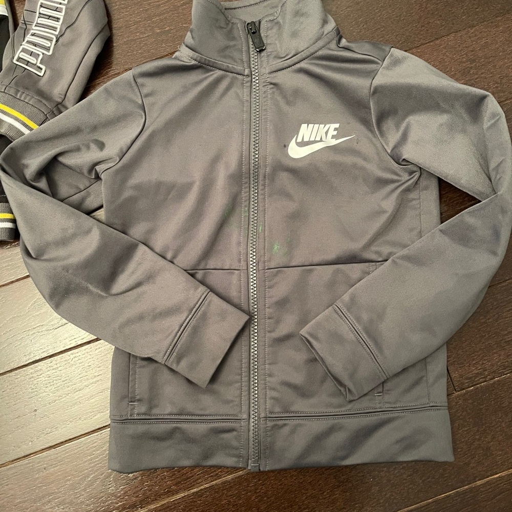 Two zip ups paint stain on Nike size 4